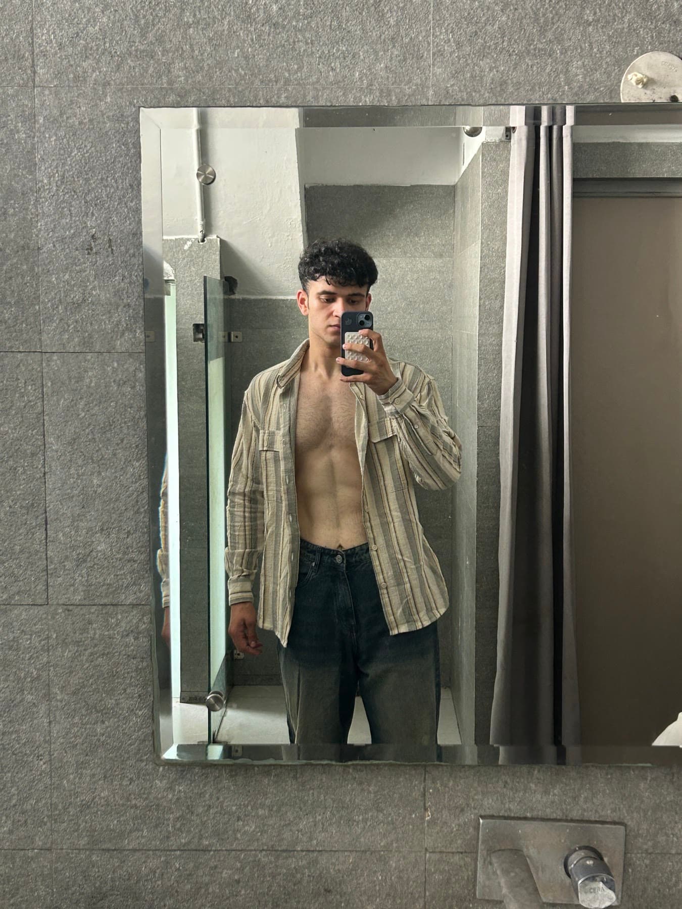Siddharth in a striped shirt, mirror selfie